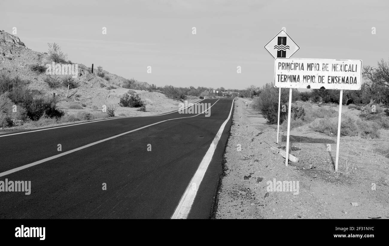 Road sign on federal highway 5 announcing the end of the municipality of Ensenada and the start of Mexicali near San Felipe, Baja California, Mexico. Stock Photo