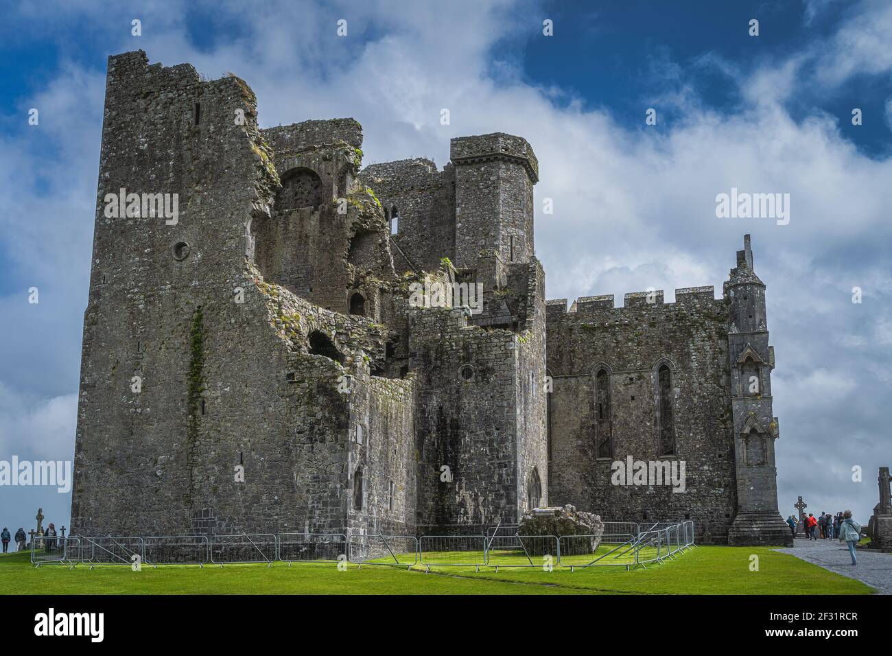 Cashel, Ireland, August 2019 Tourists admiring and sightseeing majestic ancient ruins of Rock of Cashel castle Stock Photo