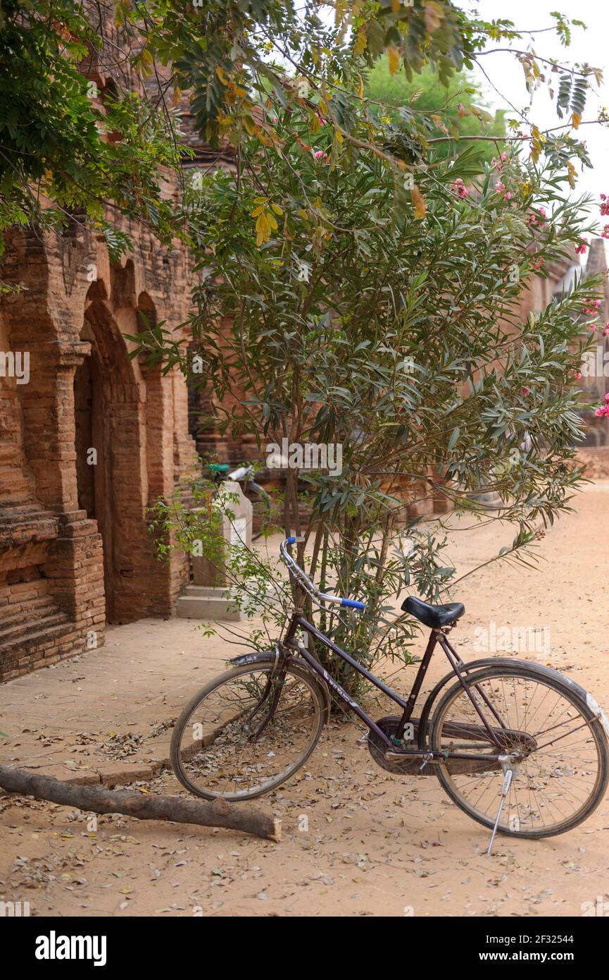 Bicycle parked by temple ruins to be used by tourists in Bagan Myanmar for local transportation Stock Photo