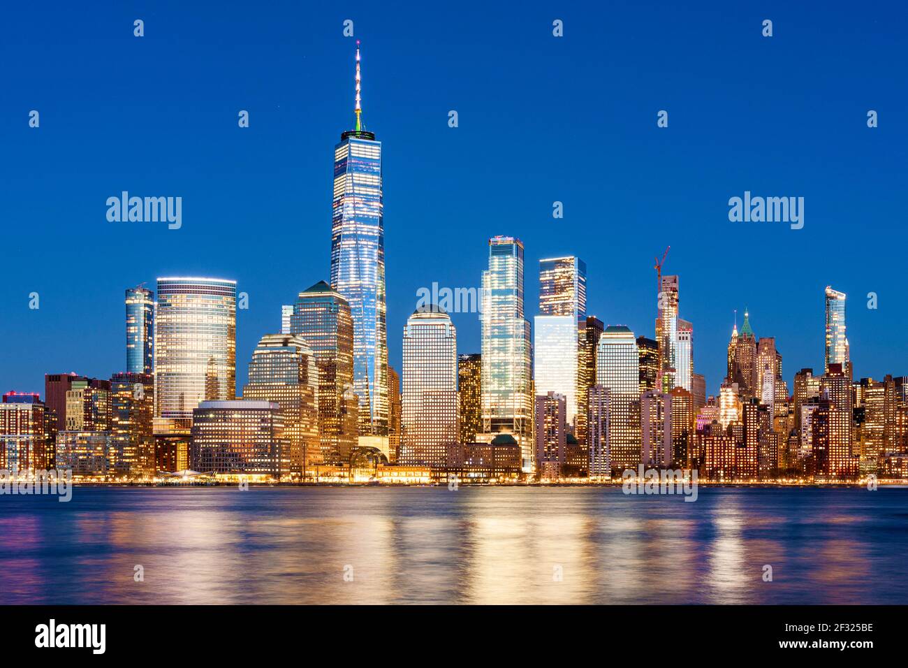 New York Skyline Lights at Night, Lower Manhattan with Freedom Tower and World Financial Center, Hudson River, New York City. Stock Photo