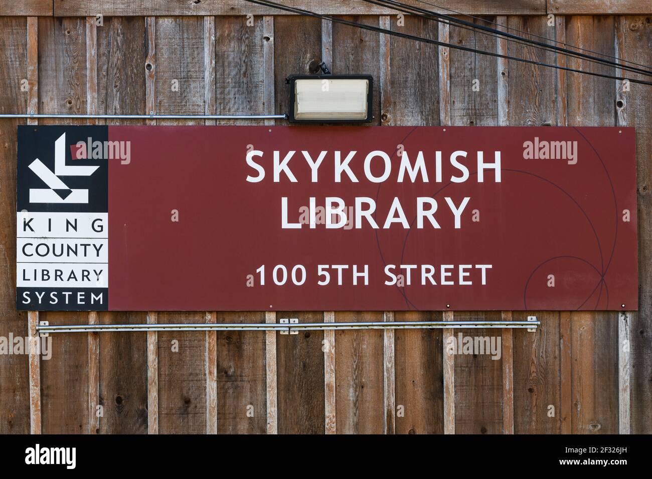 Sign on the side of the wooden library building in the town of Skykomish in the Cascade Mountains in rural King County Washington Stock Photo