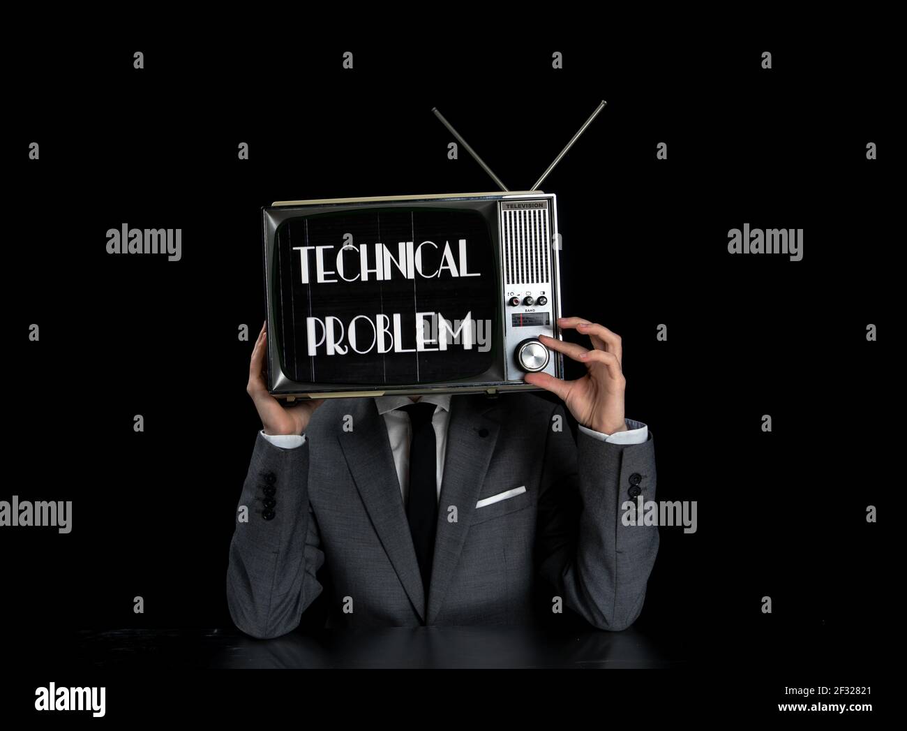 Man wearing suit with TV on head Stock Photo