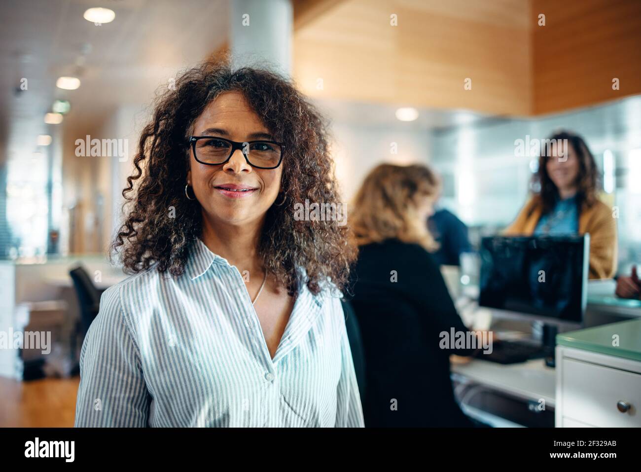 Portrait of a confident businesswoman standing in office. Mature woman working as an administrator in municipal office looking at camera. Stock Photo