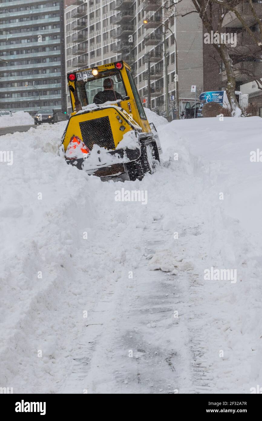 sidewalk snow plow moving snow after march snowstorm 2017, Montreal, Qc