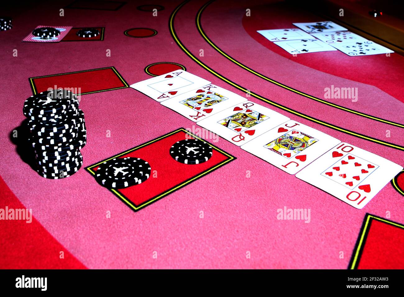 On the red table card set is a flush royal. Card club. Card game. Gaming chips on the table Stock Photo - Alamy
