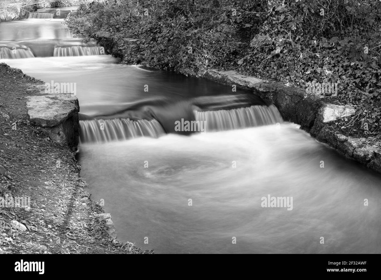 Rushing water in waterfall rapids captured in long exposure as water ...