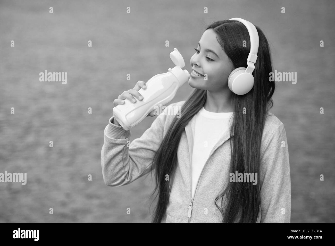 child drinking mineral water from plastic bottle for healthy lifestyle