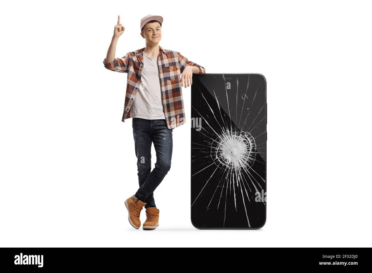 Young male leaning on a phone with a broken screen and pointing up isolated on white background Stock Photo