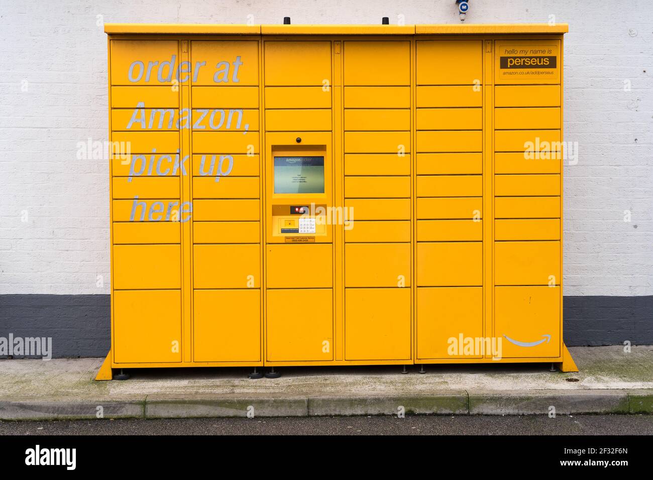 Outdoor amazon locker for click and collect order installed against a while wall, London