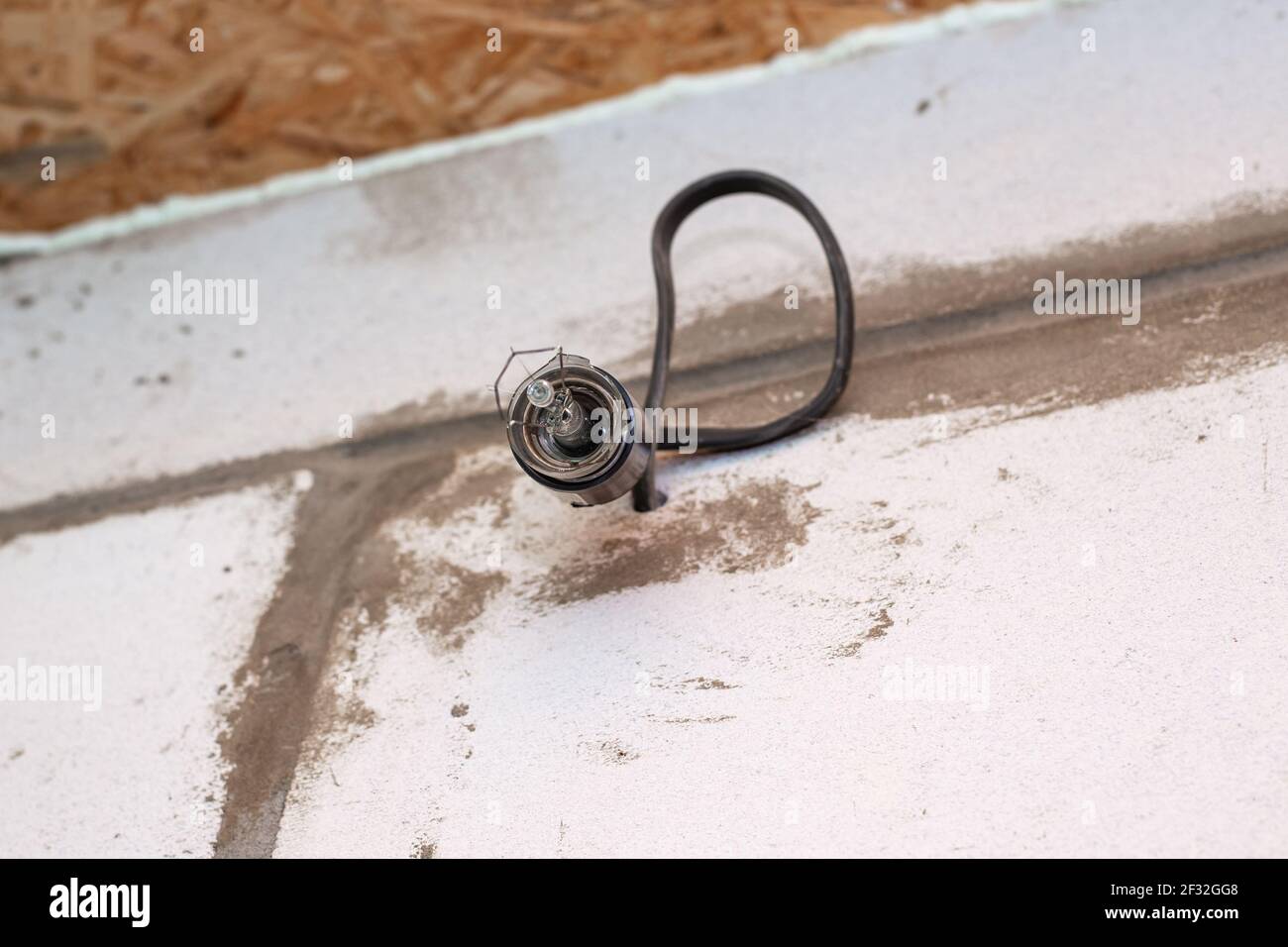 On the wall in an electric socket are fragments of a bursting light