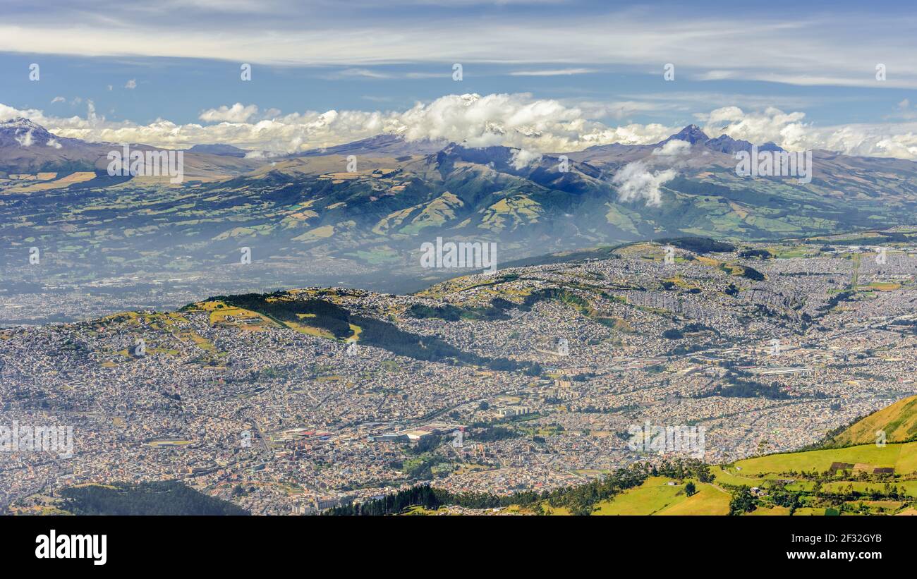 Panoramic areal view of Quito, the capital of Ecuador, seen from Pichincha Volcano and Teleferico during hiking on a sunny day Stock Photo