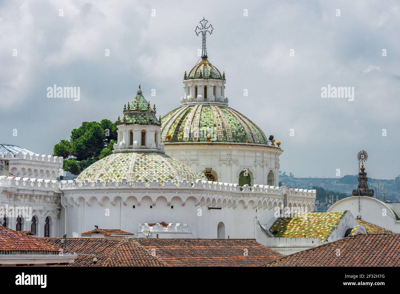 Latin American baroque metropolitan cathedral of Quito, Pichincha Province, Ecuador, with some antique baroque buildings in front and blue sky Stock Photo