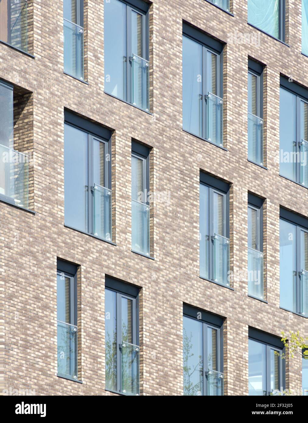 Modern architecture background. Rerctangular windows and clinker bricks fascade. Stock Photo