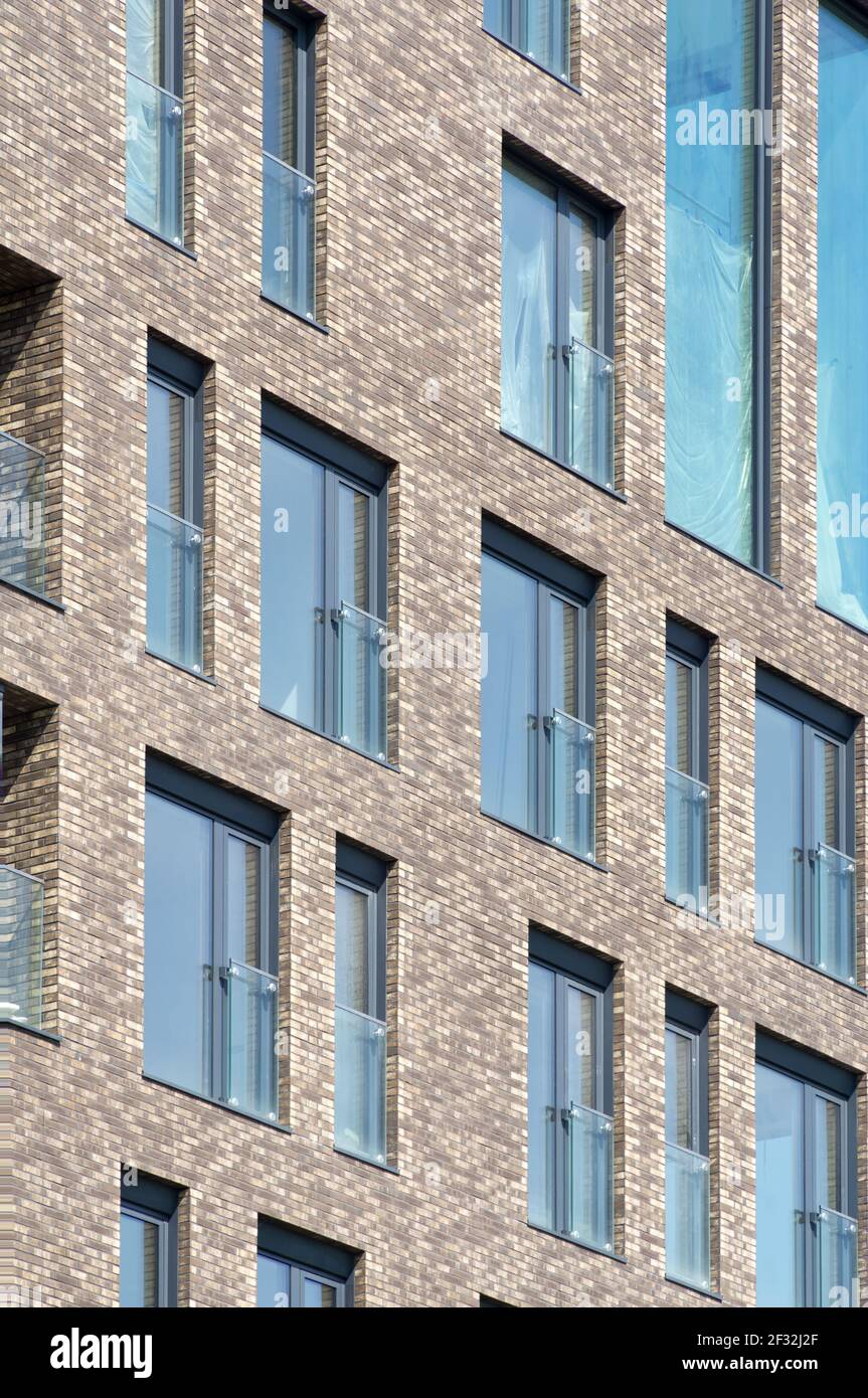 Modern architecture background. Rerctangular windows and clinker bricks fascade. Stock Photo