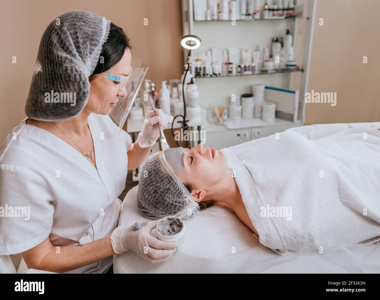 Esthetician applying clay mask hi-res stock photography and images - Alamy