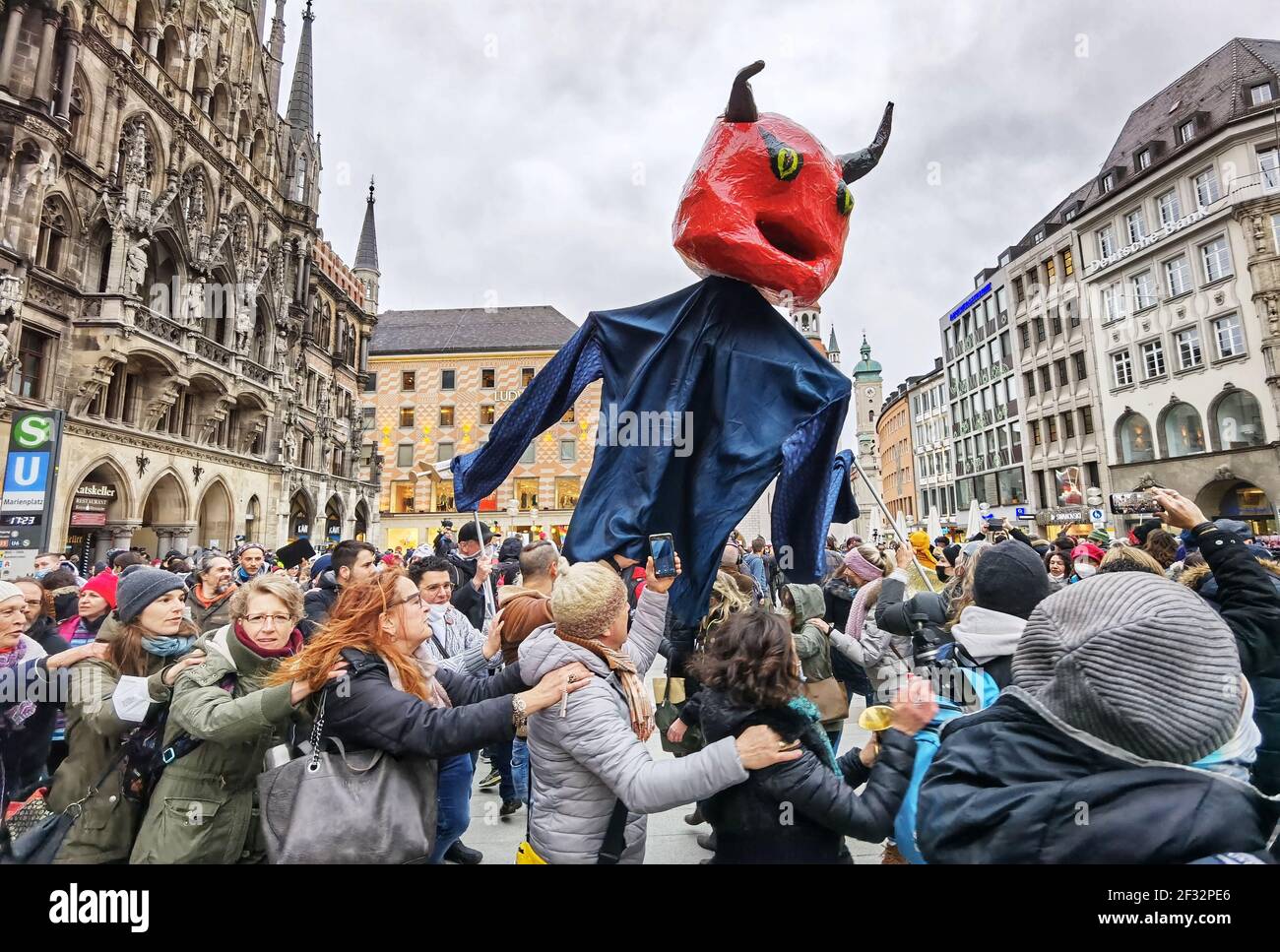 Munich, Bavaria, Germany. 14th Mar, 2021. Corona deniers and anti-maskers partake in a Polonaise dance- without distancing and most without masks at Munich's Marienplatz. Despite rising British variant Corona numbers, police maintained a laid-back approach. Using the occasion of Germany going into a period of anti-Corona measures approximately one year ago, Corona deniers and anti-maskers led by QuerdenkenÃ¢â‚¬â„¢s Markus Haintz assembled at MunichÃ¢â‚¬â„¢s Marienplatz and then at the Maxmonument in an effort to protest against the Bavarian Landtag and promote their initiative to dissolve it Stock Photo