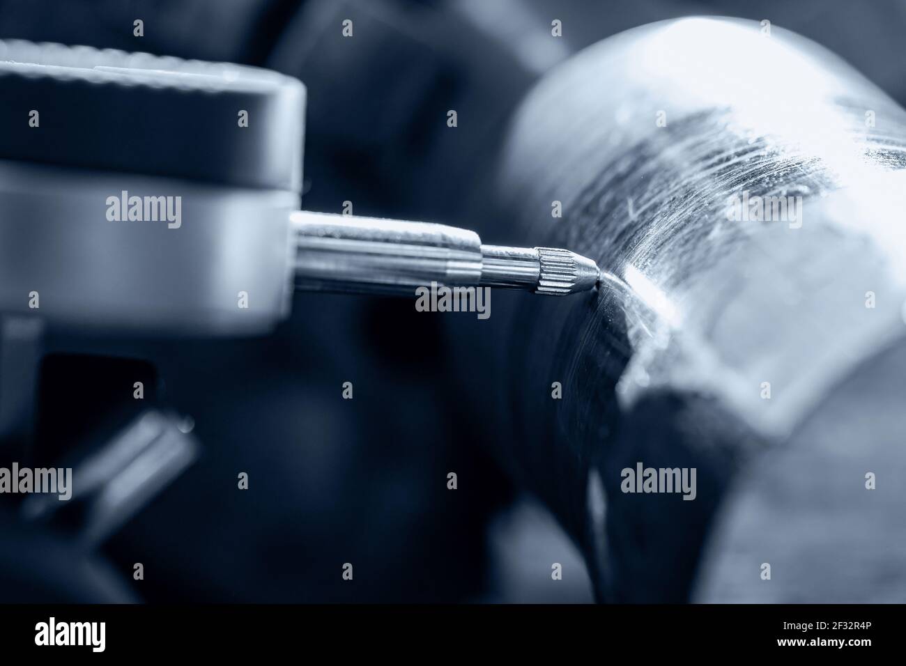 Process CNC lathe machine cutting metal. Operator measures vibration of