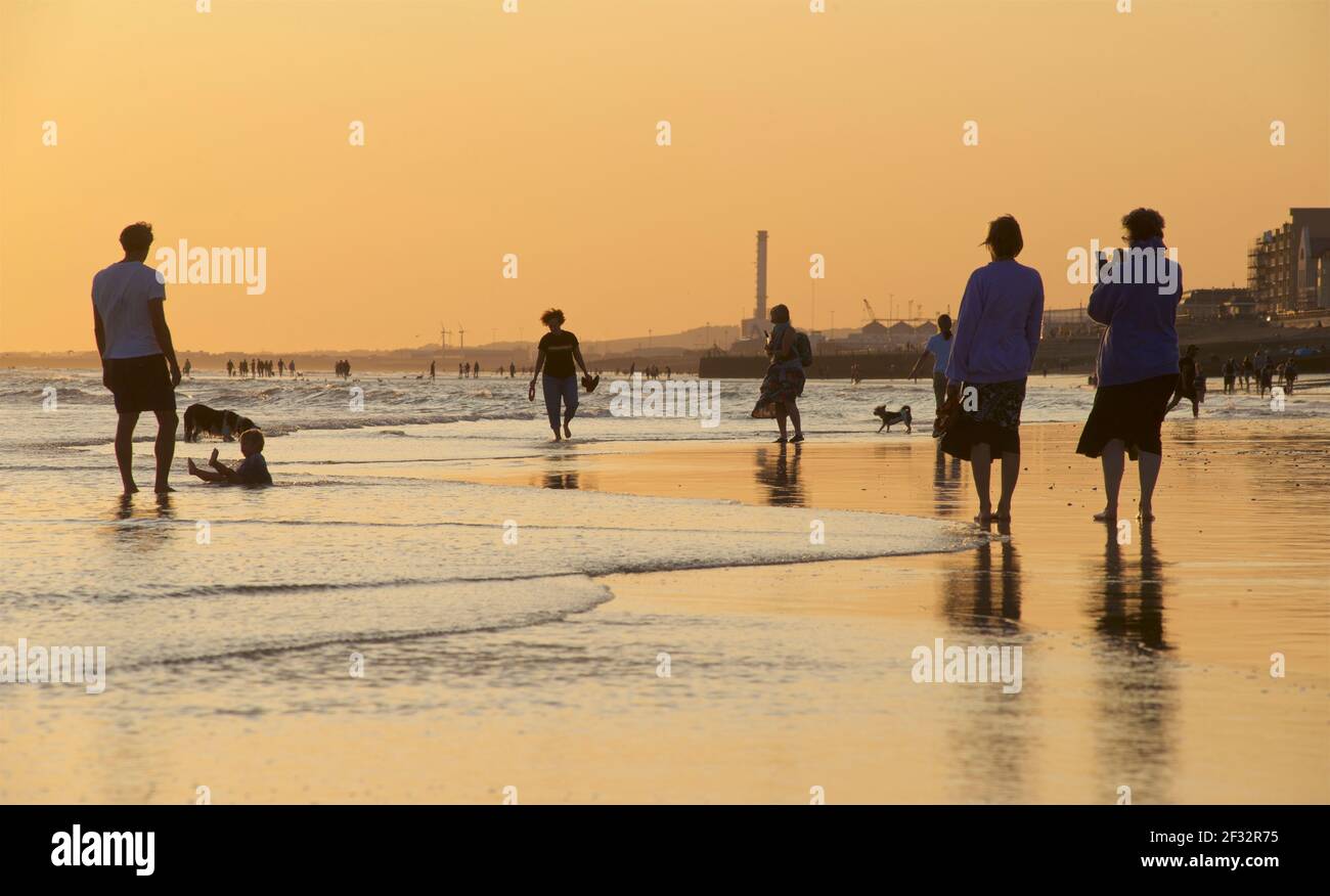 Brighton and Hove beach at low tide. Silhouettes at sunset. East Sussex, England Stock Photo Alamy