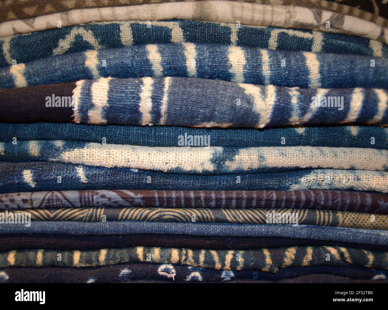 Stack of indigo, tie dyed textiles from West Africa Stock Photo