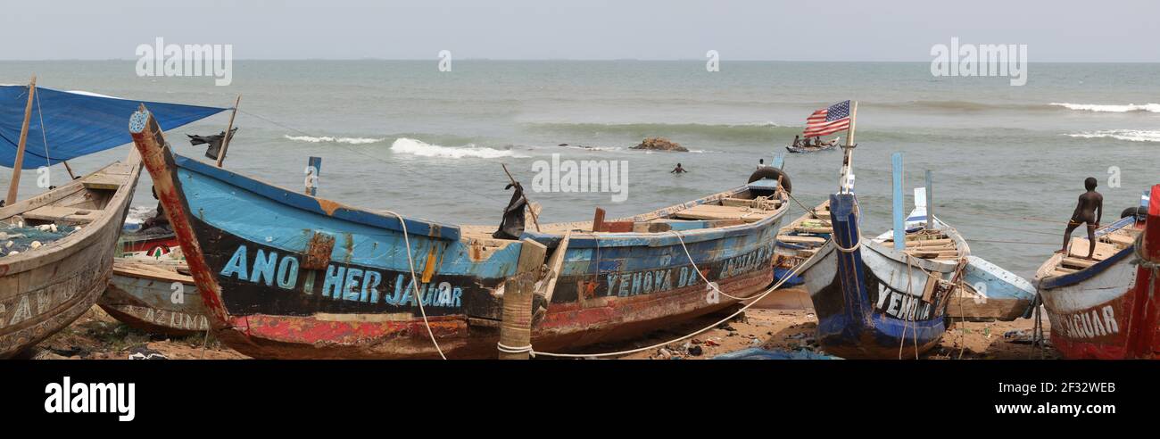 Fishing village beach shore near Accra Ghana. Old handmade fishing boats. Hand build boats. Poor sanitation, poor neighborhoods. Stock Photo