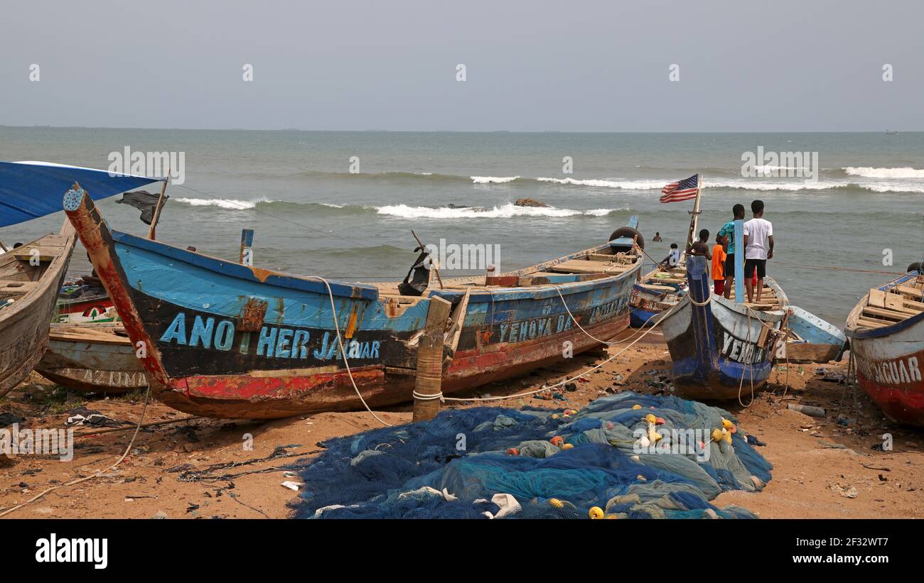 Wooden fishing boats village Ghana Africa. Old handmade fishing boats fish together at night for the local village. Stock Photo