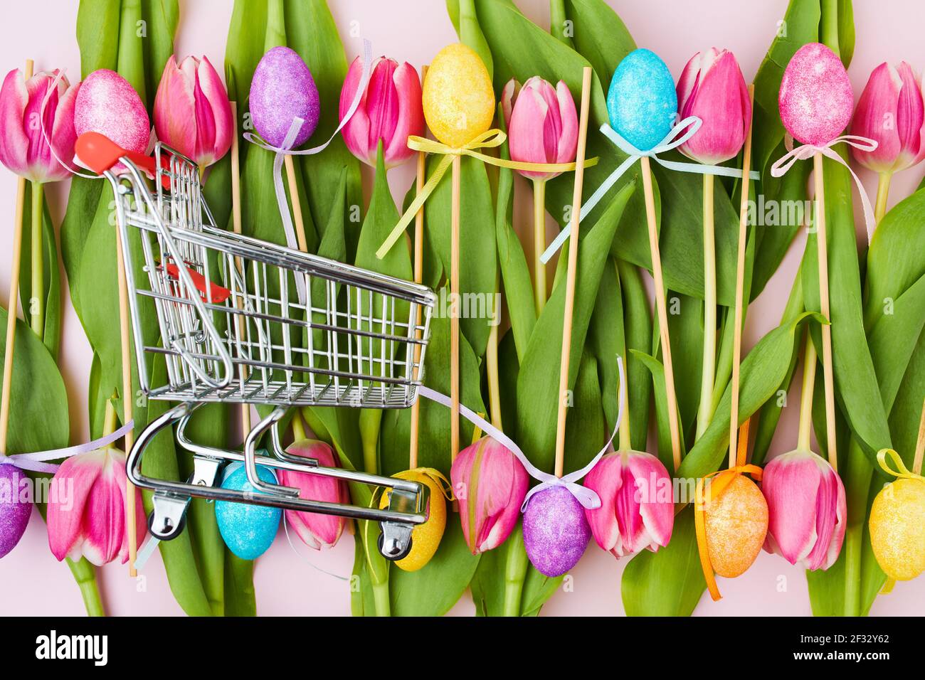 spring flat lay with tulips, easter eggs and shopping cart isolated on ...