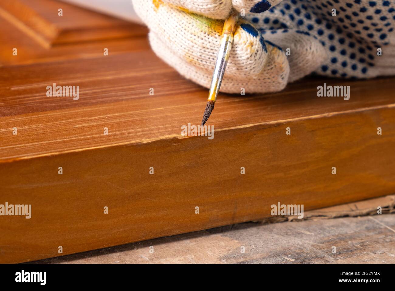restoration of a wooden door closeup,repairing scratches on a wood