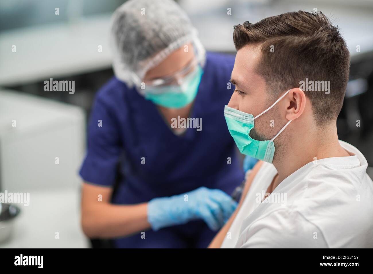 In the laboratory at the hospital, a nurse gives an injection into the ...