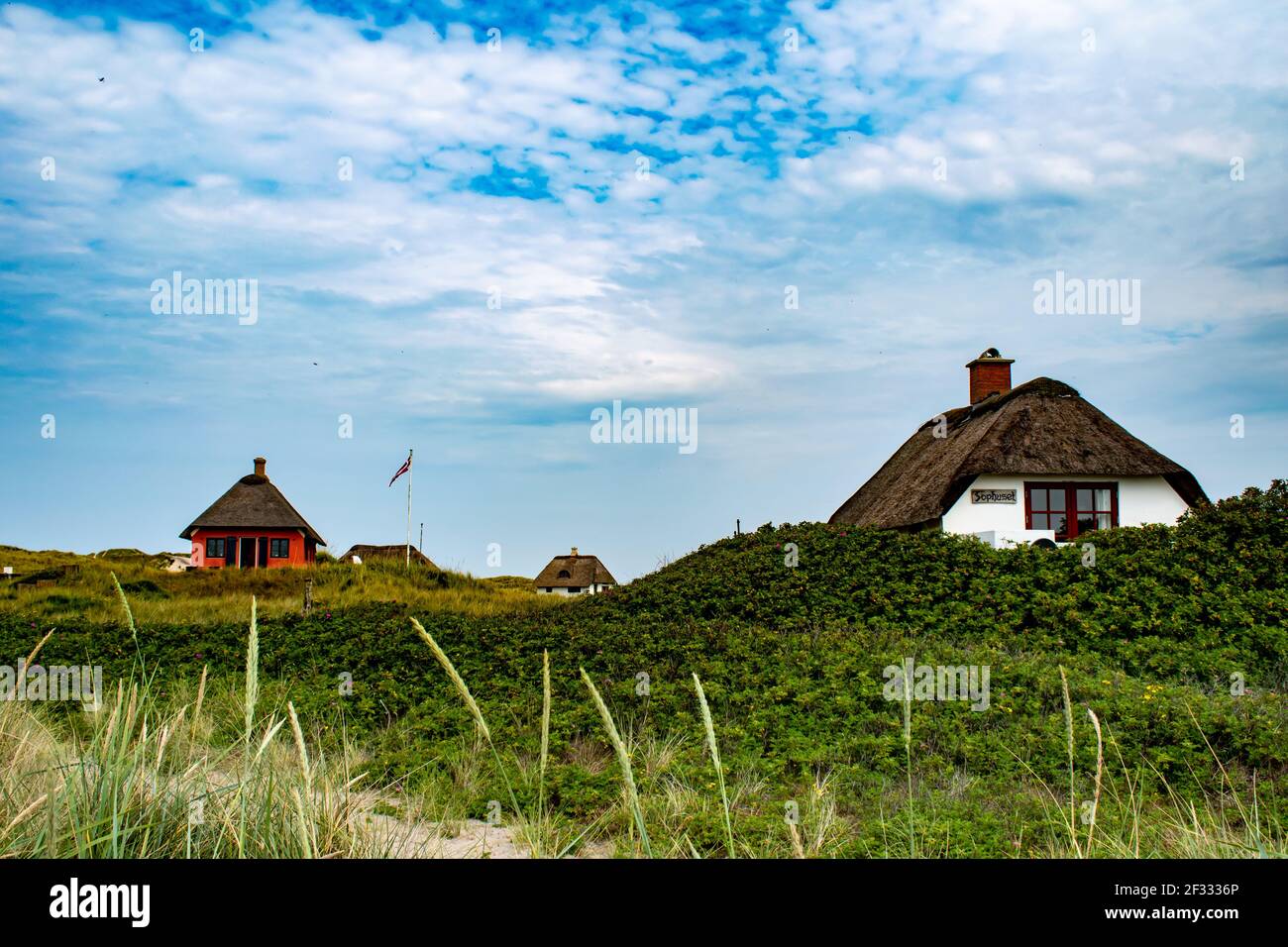 Traditional danish houses with thatched roof on shores of Blavand beaches Stock Photo