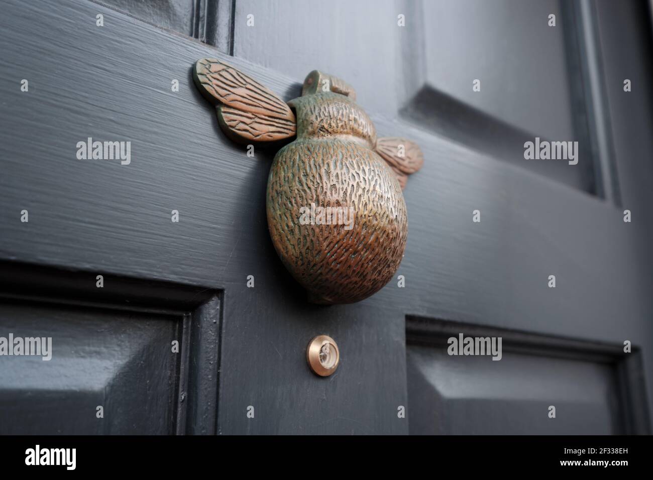 Vintage metal door knocker in shape of a bumble bee Stock Photo