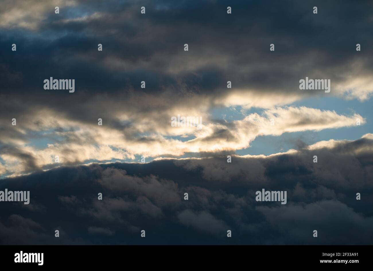 Dramatic colorful sky, during sunset. Huge clouds formations. Stock Photo