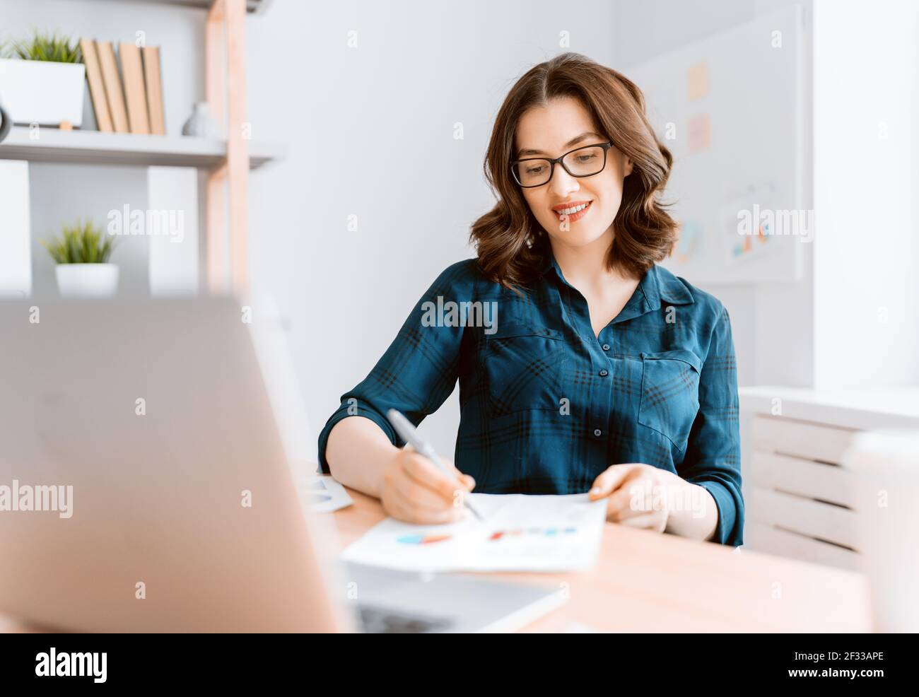 Happy casual beautiful woman working on a laptop at home Stock Photo ...