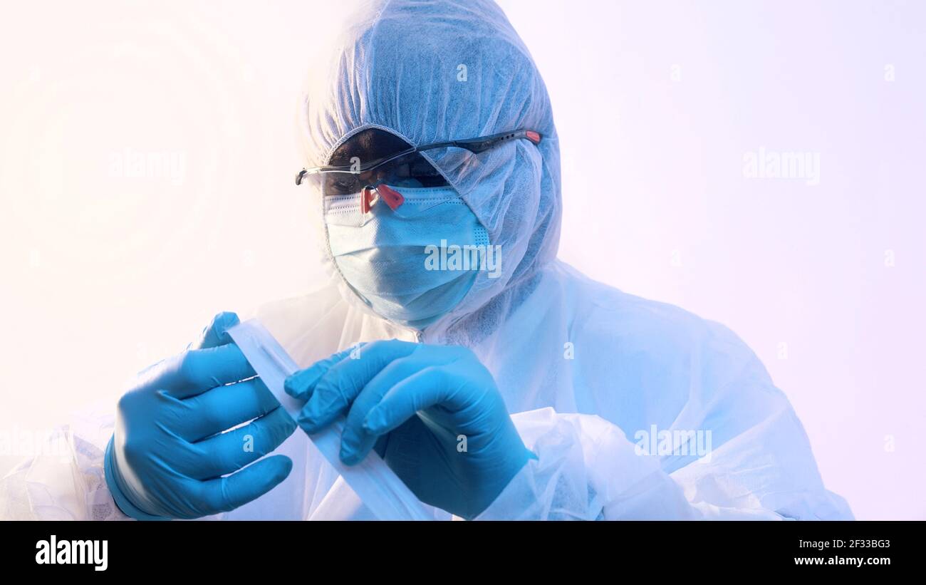 Vaccination and immunization against covid-19. Doctor opening needle. Close up. Vertical. High quality photo Stock Photo