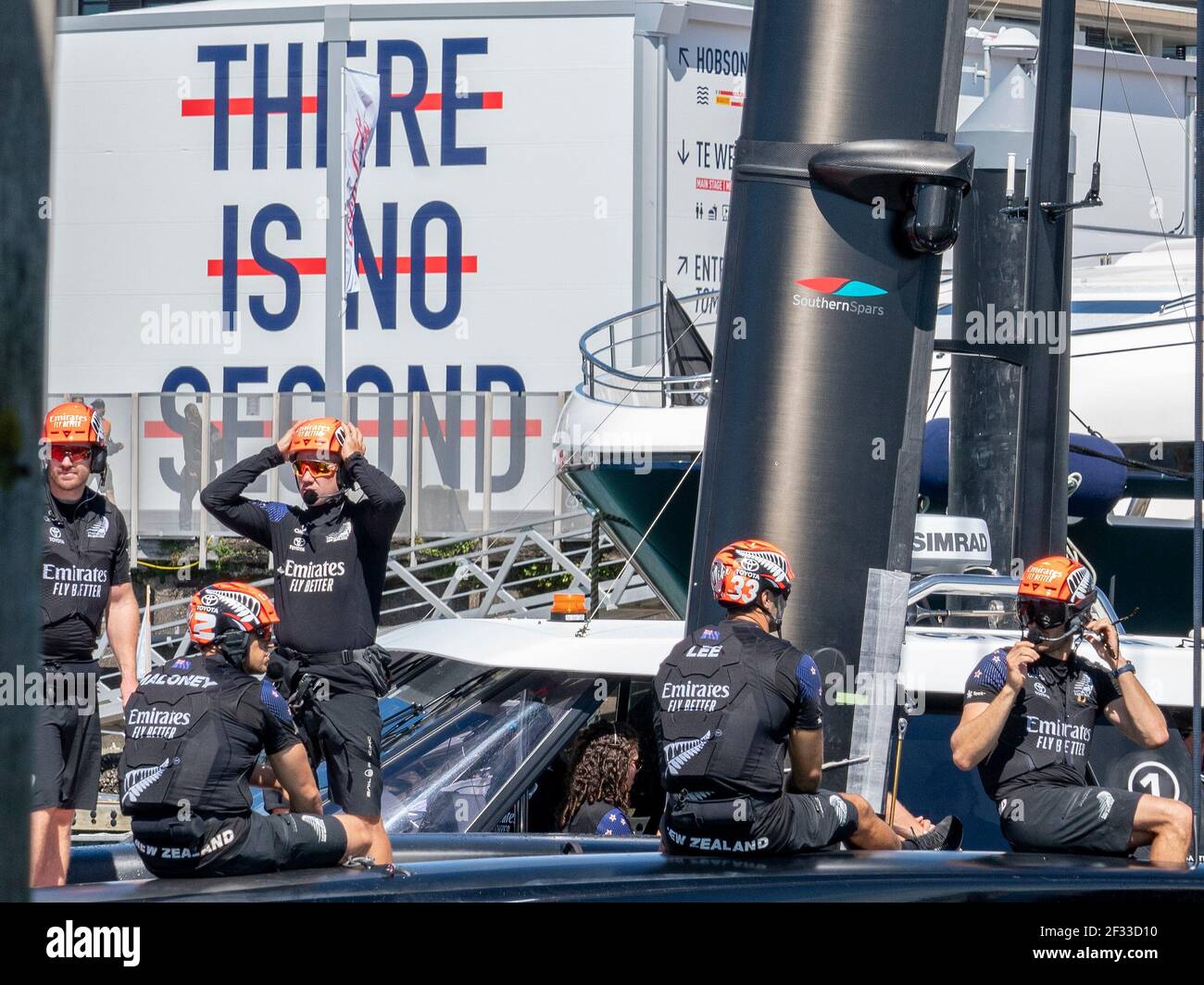 Auckland, New Zealand, 15 March, 2021 -  Emirates Team New Zealand (ETNZ), skipper  Peter Burling  (right) onboard Te Rehutai as the boat passes a sign saying 'THERE IS NO  SECOND' on leaving dock ahead of Day 5 of the 36th America's Cup.  ETNZ won both races and leads the series 5-2. Credit: Rob Taggart/Alamy Live News Stock Photo