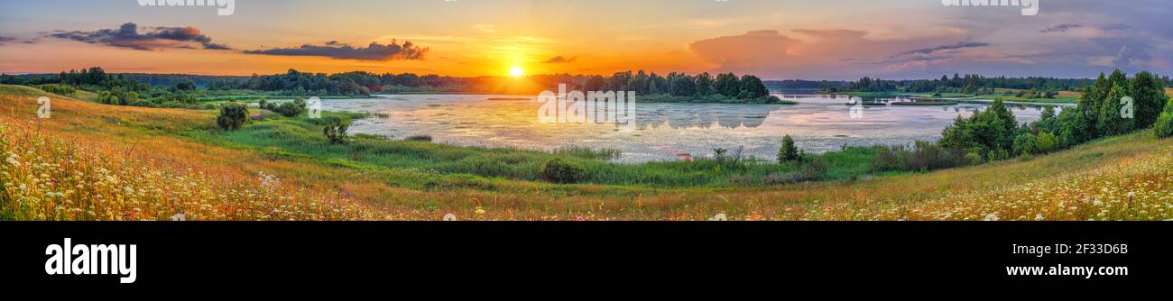 Beautiful landscape with colorful sunset over forest lake Stock Photo