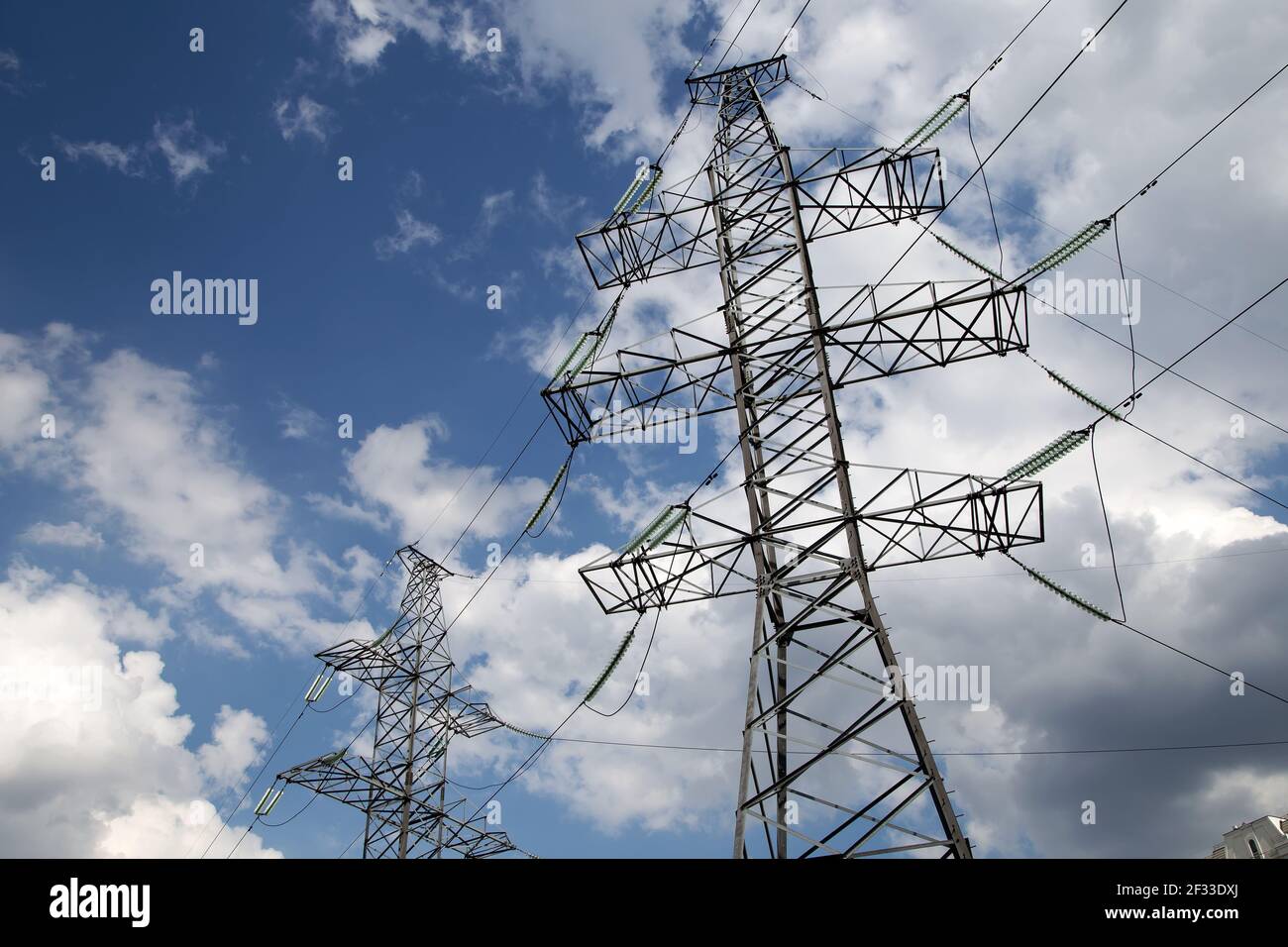 Electricity pylons and line against the blue sky and clouds Stock Photo ...