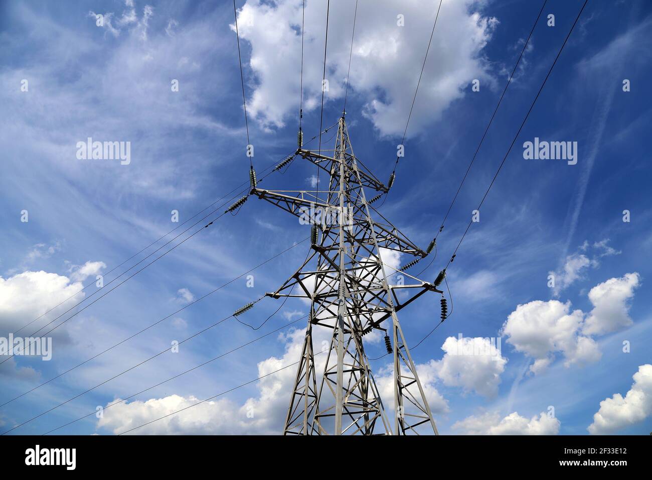 Electricity pylons and line against the blue sky and clouds Stock Photo ...
