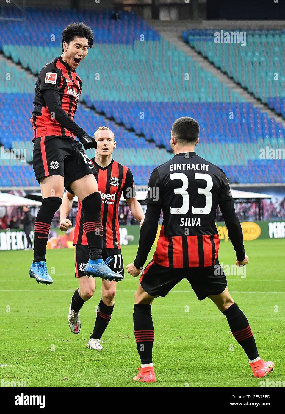 Leipzig. 15th Mar, 2021. Kamada Daichi (Top) of Frankfurt celebrates scoring during a German Bundesliga football match between Eintracht Frankfurt and RB Leipzig in Leipzig, Germany, March 14, 2021. Credit: Xinhua/Alamy Live News Stock Photo