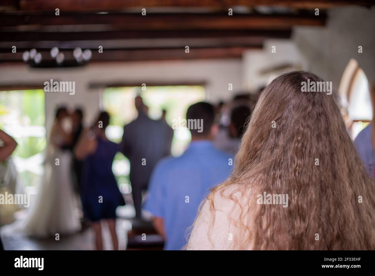 Selective focus on woman watching wedding ceremony Stock Photo