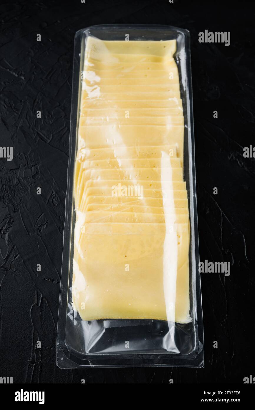 https://c8.alamy.com/comp/2F33FE6/slices-of-yellow-cheese-sealed-pack-on-black-background-2F33FE6.jpg