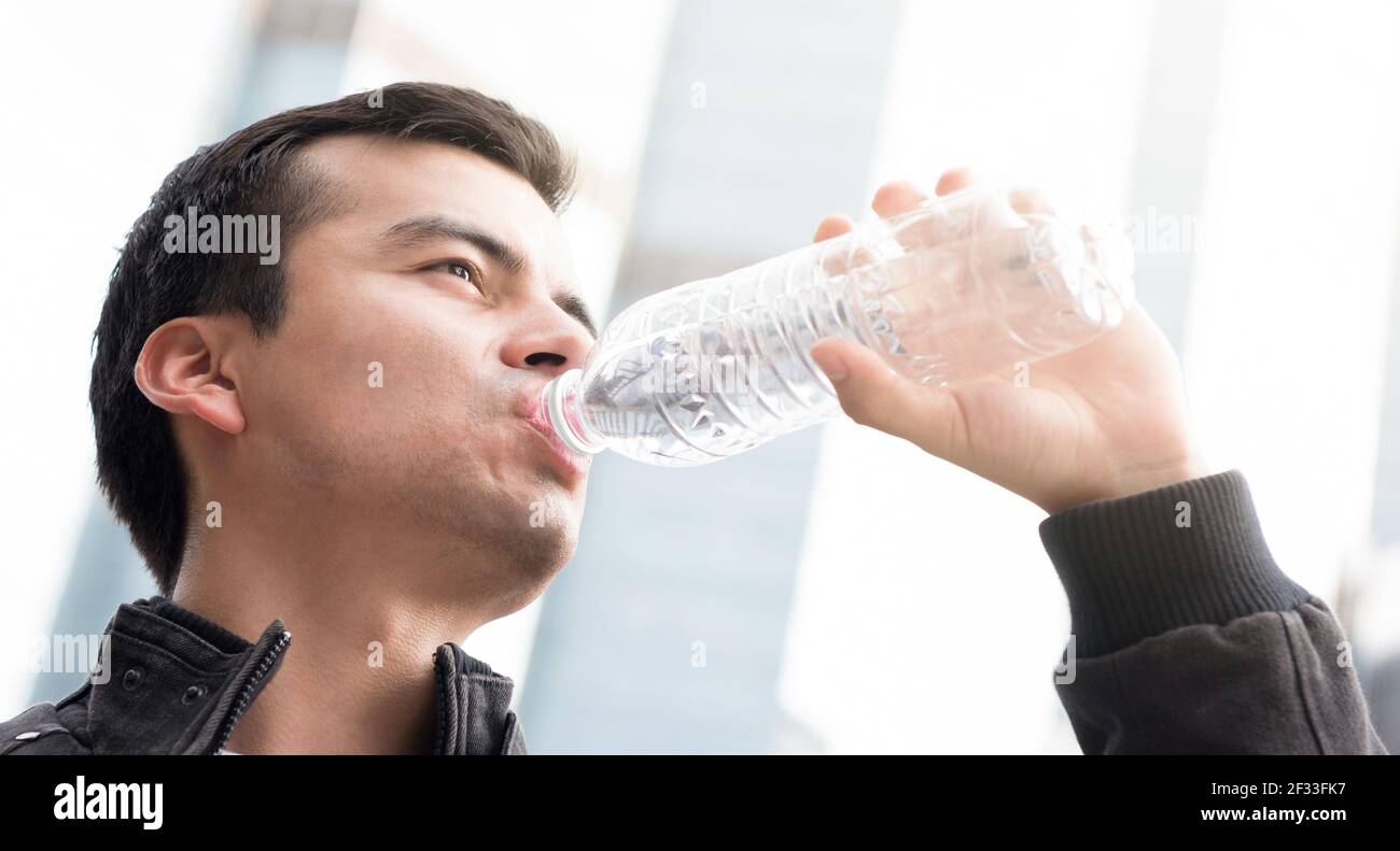 A man drinking water from bottle Stock Photo