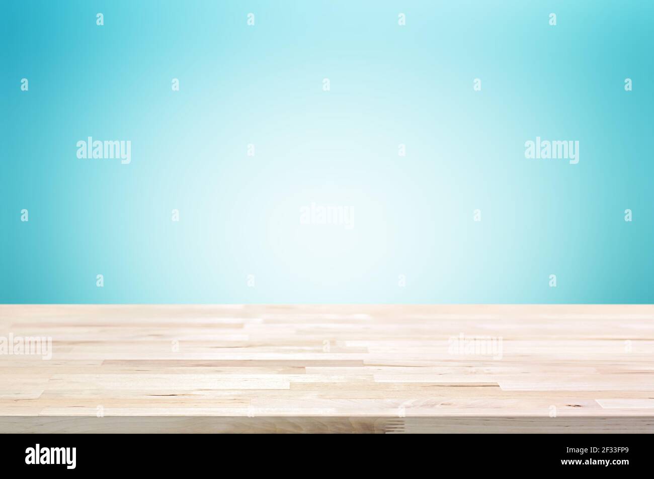 Wood table top on light blue gradient abstract background - can be used for display or montage your products Stock Photo
