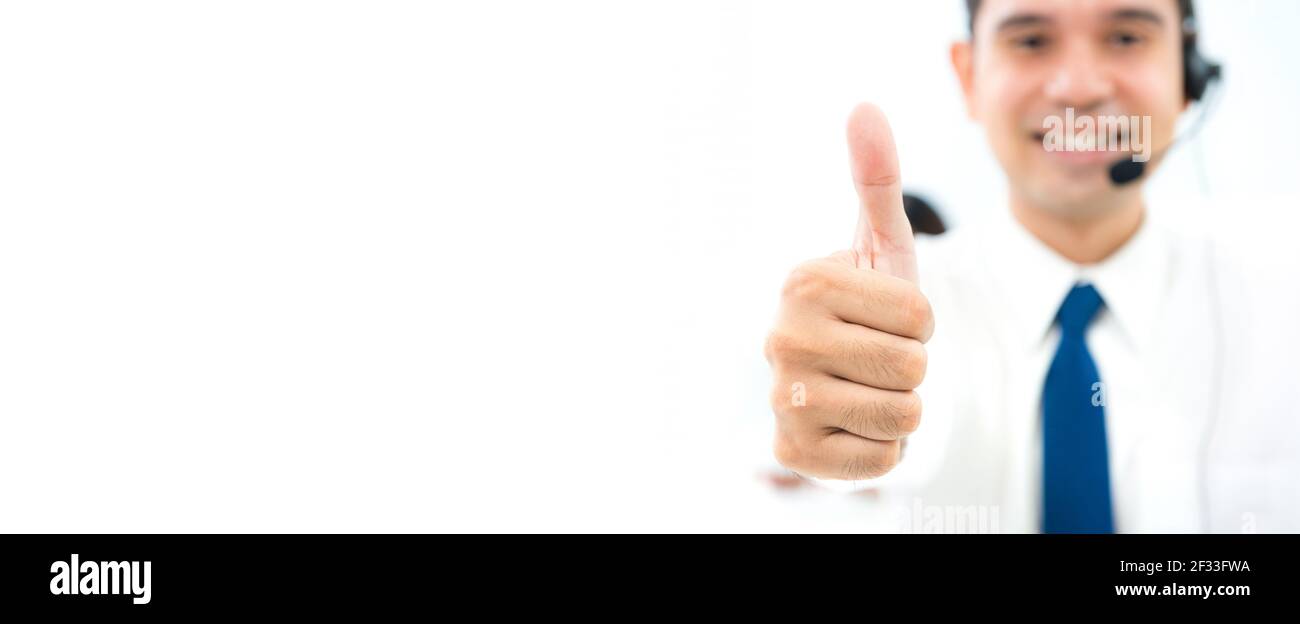 Male call center staff giving thumbs up - panoramic banner background with copy space Stock Photo