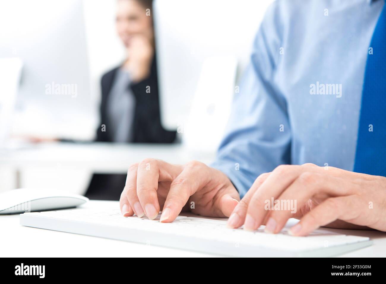Businessman hands typing computer keyboard on working table in the office Stock Photo