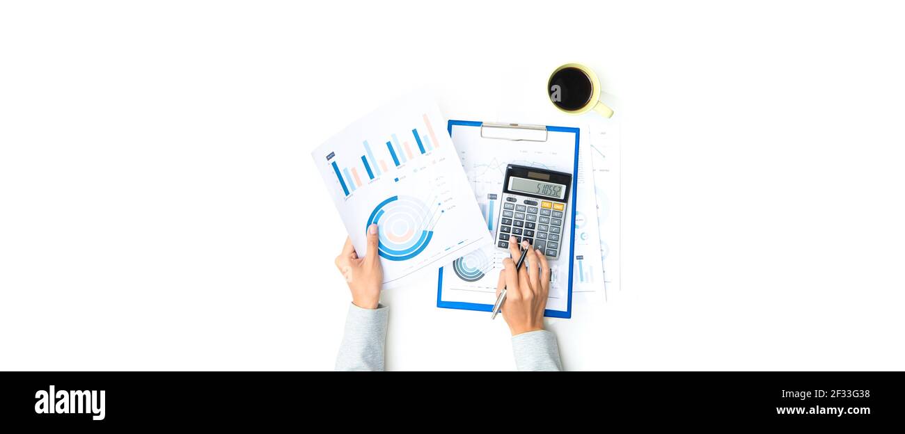 Top view of woman hands calculating and working with financial graph documents on white table - data analysis concept, panoramic banner background Stock Photo