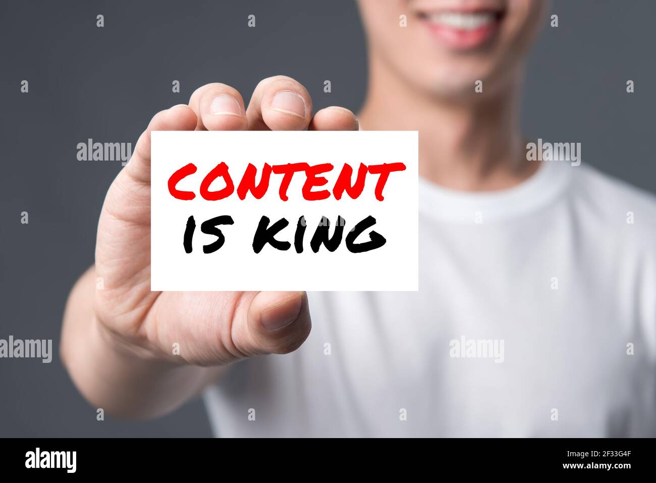 CONTENT IS KING, message on the card shown by a man Stock Photo