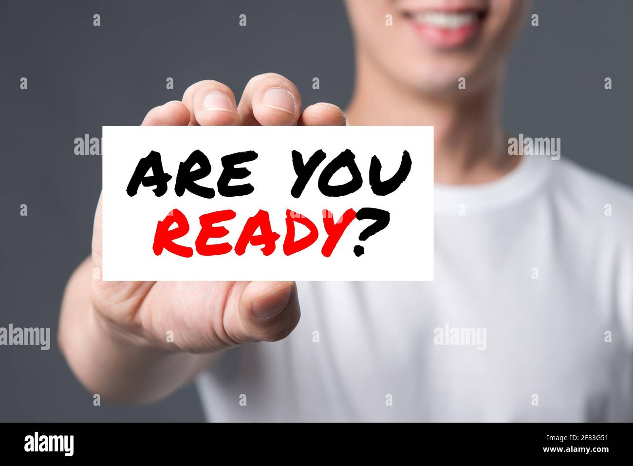 ARE YOU READY? message on the card shown by a man Stock Photo
