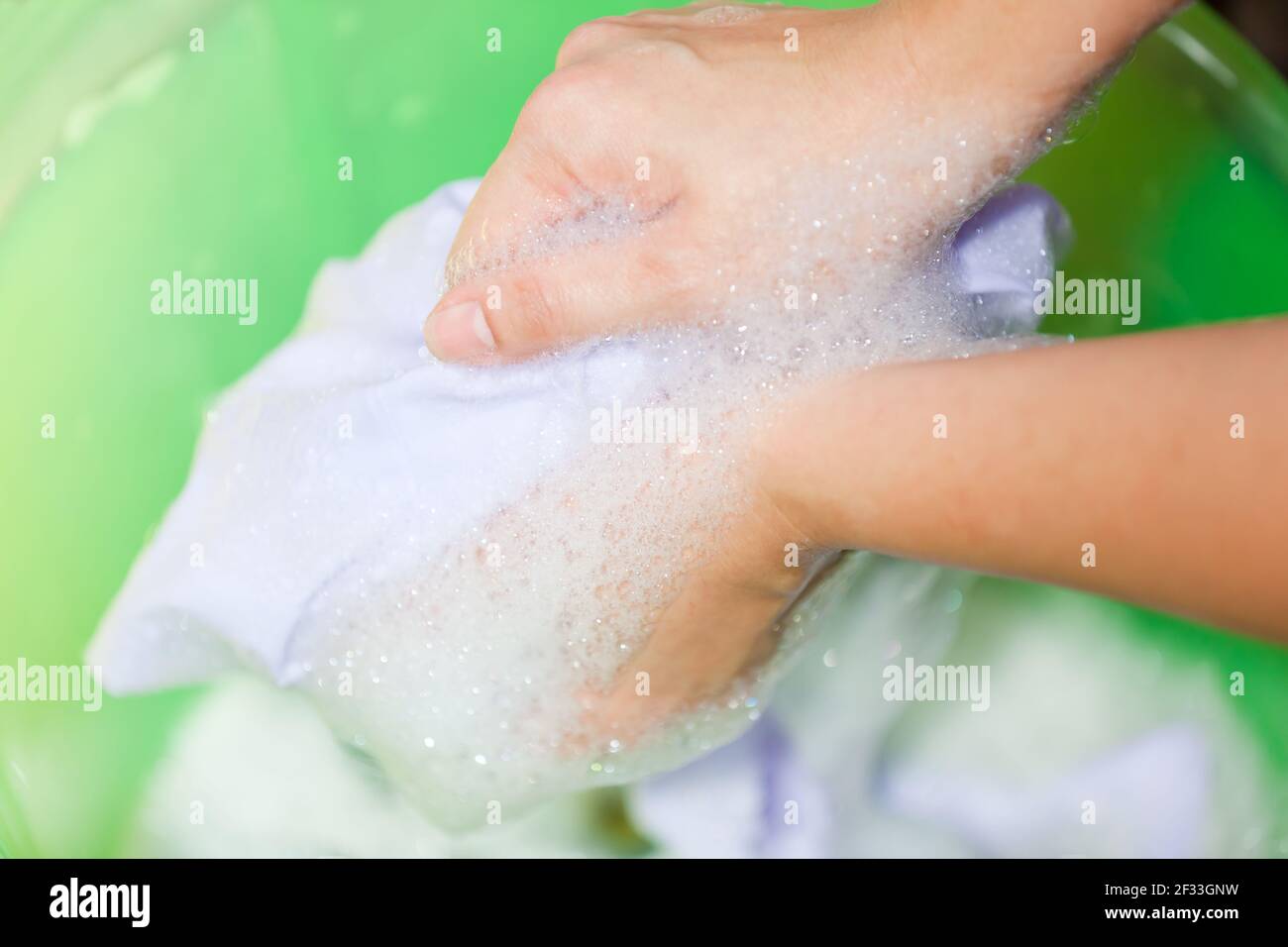 Hand washing clothes in bowl hires stock photography and images Alamy
