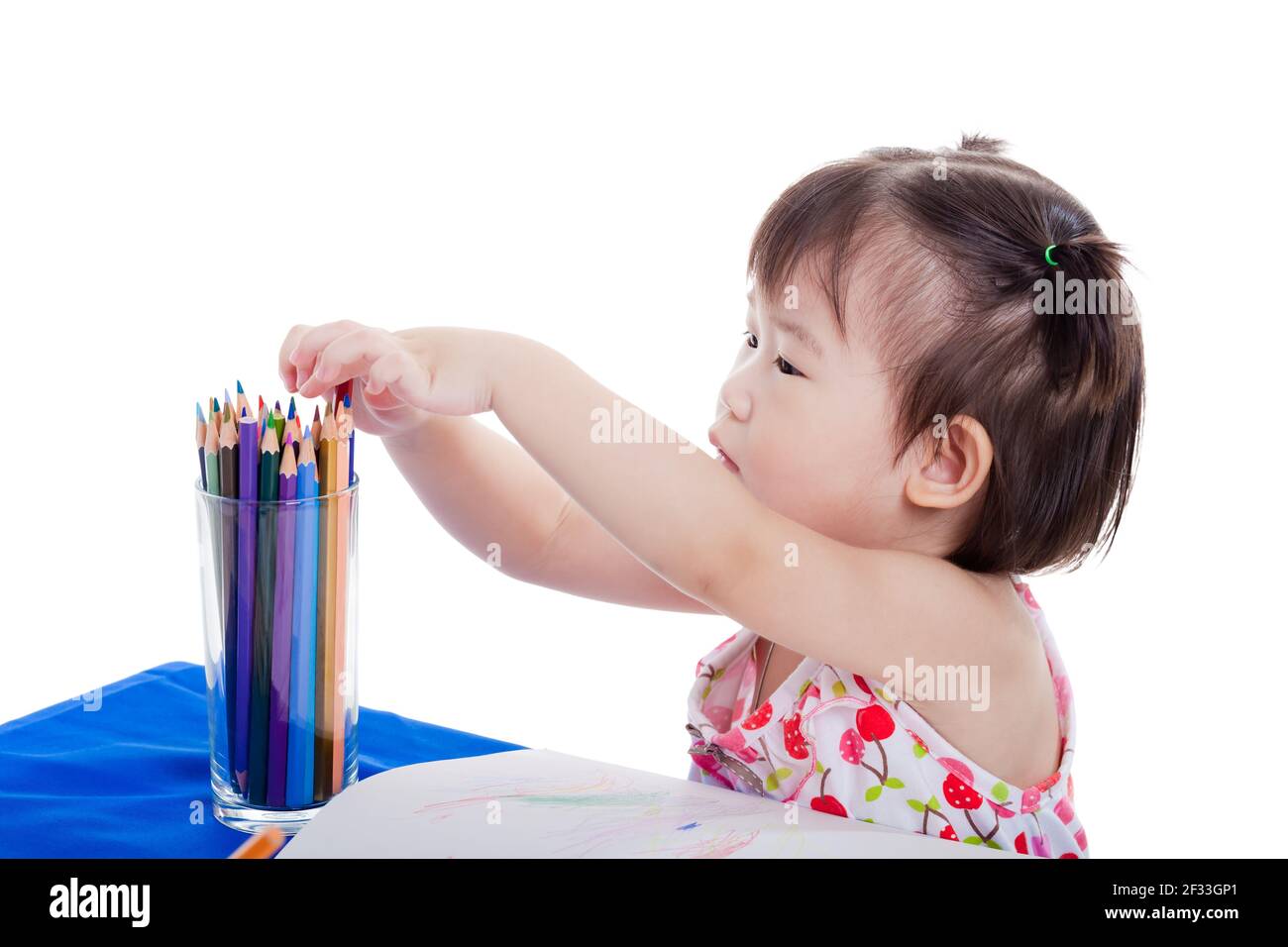 Cute little asian girl sitting at the table and choosing colour pencil for  draw picture on holiday, isolated on white background Stock Photo - Alamy