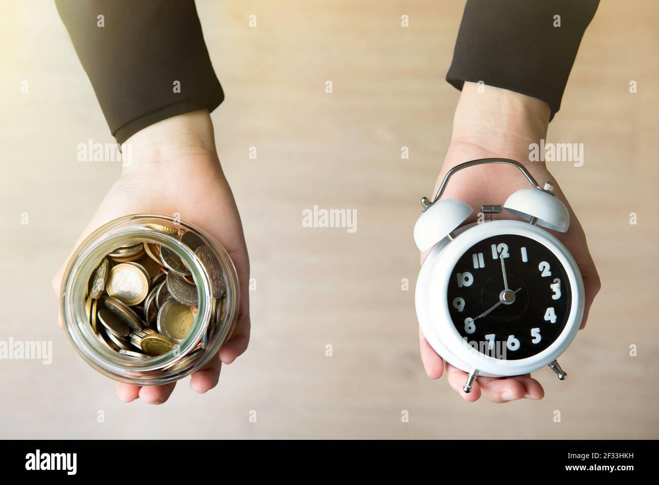 Woman hands showing money and time Stock Photo